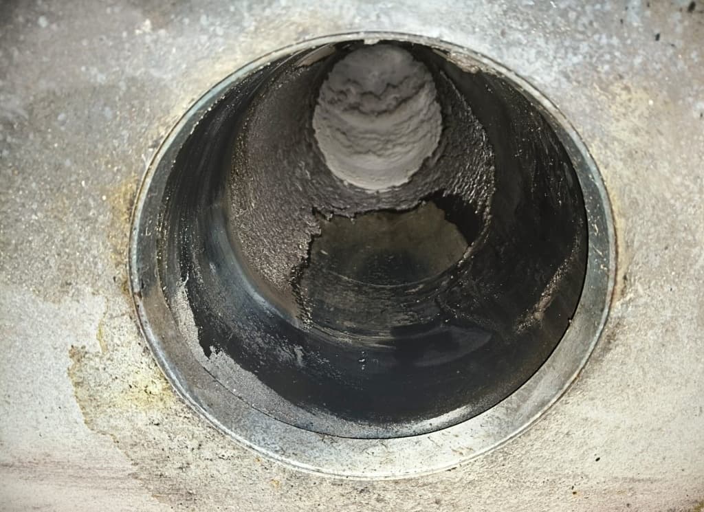 Perchloric acid fume hood cleaning: exhaust duct after cleaning with more of the metal surface exposed