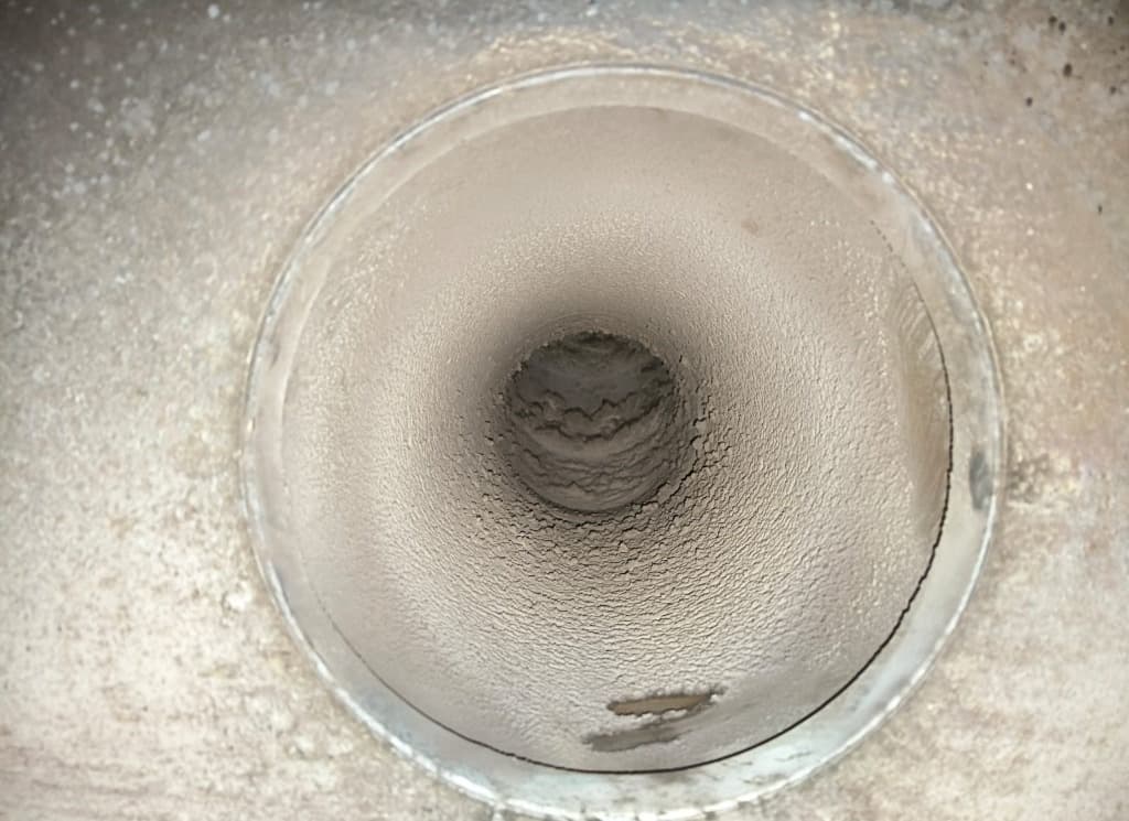 Perchloric acid fume hood cleaning: exhaust duct with visible deposits before cleaning